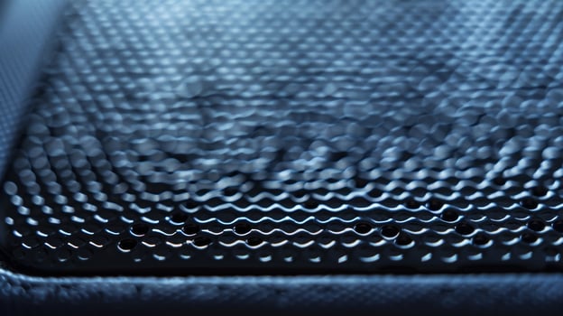 A detailed closeup of a portable SSD captures the fine details of its textured surface providing a secure grip for handling photo
