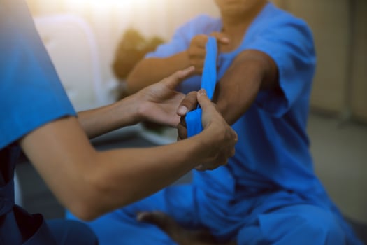 Professional physical therapist examines and cares for a young man in a physical therapy center, treating muscles and injuries of a man in a hospital. photo