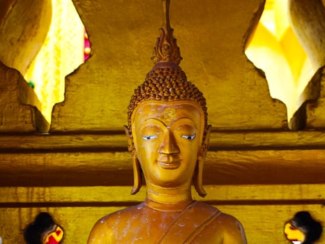 Buddha statues and sculptures at Phra That Luang or Phra Chedi Lokachulamanee is considered a very important place of worship in Vientiane, Laos. photo