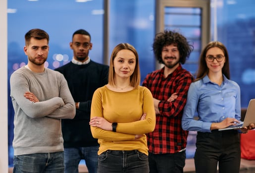 Portrait of successful creative business team looking at camera and smiling. Diverse business people standing together at startup. Selective focus photo