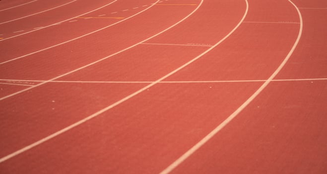 Red running track lines in the stadium. photo
