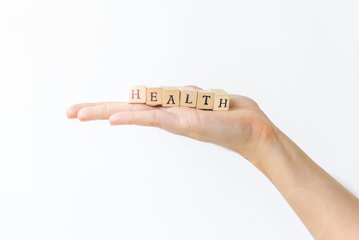 Hand holding wooden letters for health concept. photo