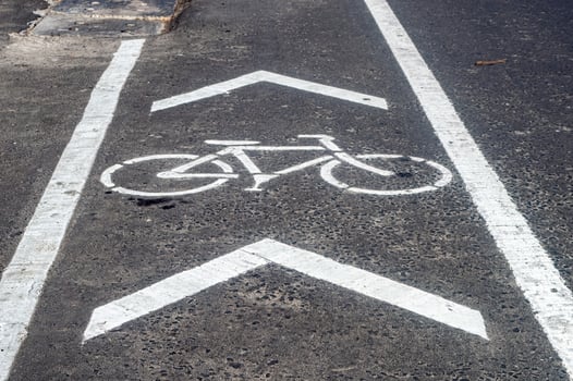 a bicycle way or bike lane on the side of an asphalt road in the city of Surabaya photo