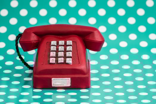 Vintage Red Telephone on Green Background with White Polka Dots. photo