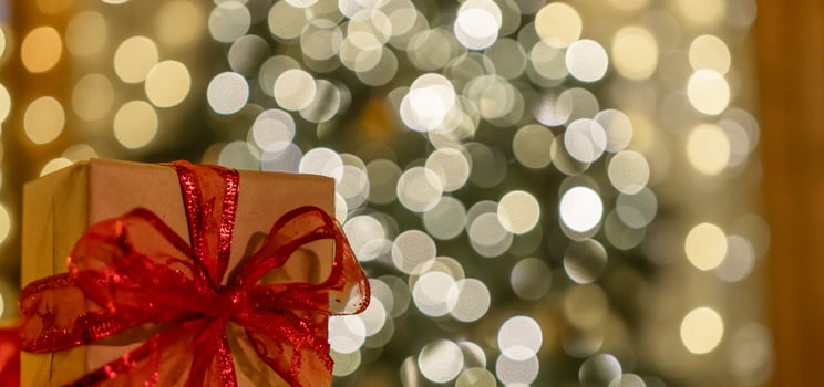 Christmas gift or present box, against magic bokeh background. Beautiful Christmas gift boxes with ribbon photo