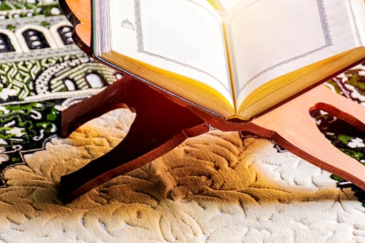 Islam holy book of Muslims, the Quran, is placed on a wooden stand. photo