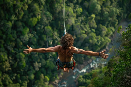 Rope jumping or bungee jumping, girl jumping to the bottom, extreme background. photo
