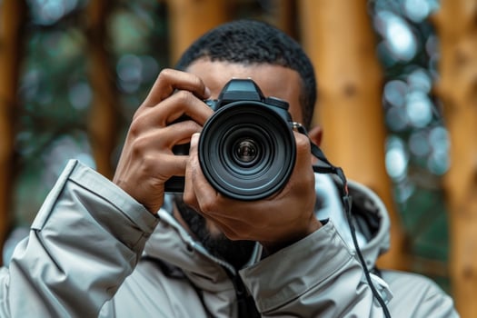 man hand holding camera looking through lens. photo