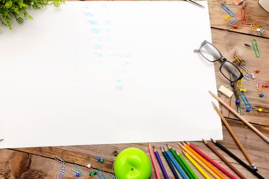 A desk with many stationery items placed,Large blank paper to put different content messages. photo
