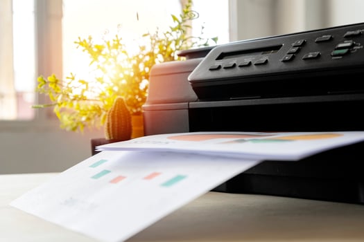 The printer is fully functional,Located on the desk. photo