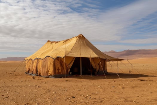 Traditional desert camp tent in sandy landscape photo