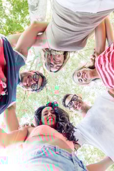 group of smiling friends in circle - bottom view photo