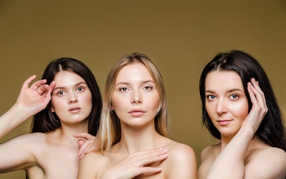 Three Young Women with Expressive Poses in a Beauty Portrait photo