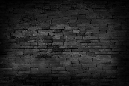Black Unplastered Brick Wall Texture Background in Empty Basement photo