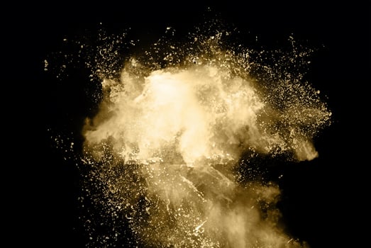 Celestial Gold Dust Explosion in Frozen Motion on Dark Background photo