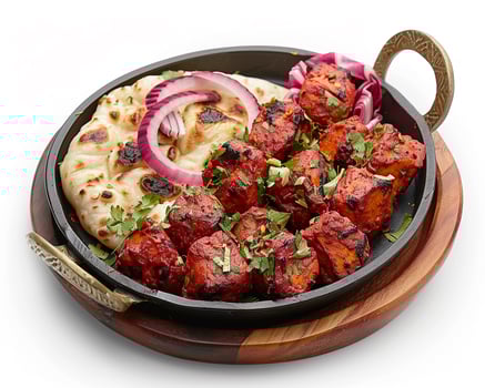 a plate with chicken and onions on it photo