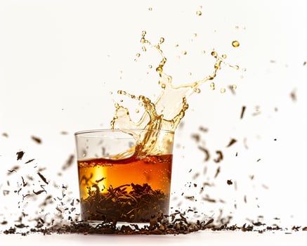 a glass of tea with a splash of liquid photo