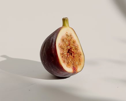 a half eaten fig on a white surface photo