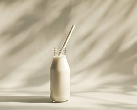 a glass bottle with a straw in it photo