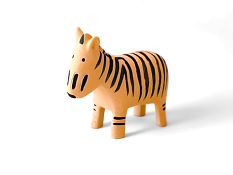 miniature wooden zebra animal on a white background photo