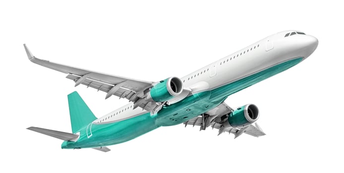 White - turquoise passenger aircraft isolated on white background photo