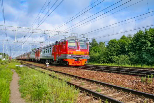 Moscow region, Russia, July 2018 Passenger electric train of the Russian Railways ED4M moves against a background of green forest photo