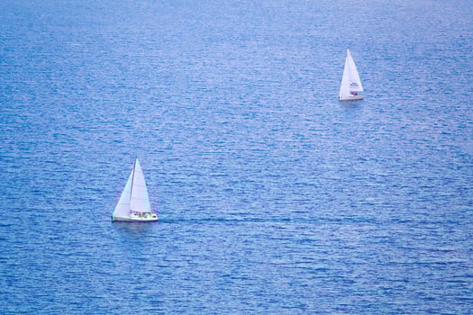 Two sailing boats on the blue water photo