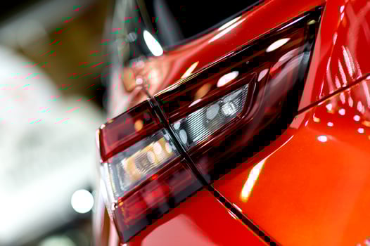 Red illuminated LED taillight on the back of a car at night photo
