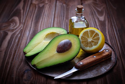 Fresh avocado on wooden background photo