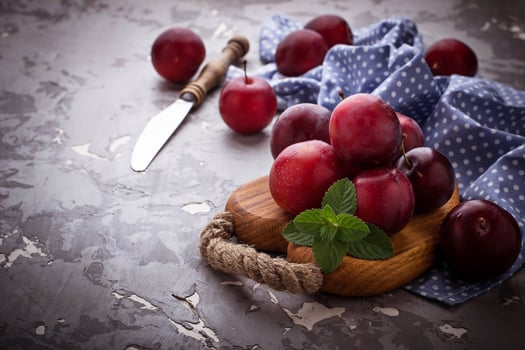 Sweet plums on wooden background photo