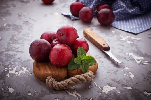 Sweet plums on wooden background photo