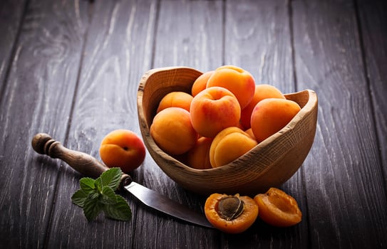 Sweet apricots on wooden background photo