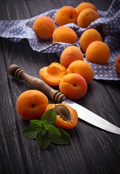 Sweet apricots on wooden background photo