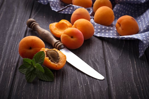Sweet apricots on wooden background photo