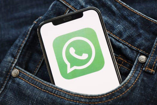 KYIV, UKRAINE - APRIL 1, 2024 Whatsapp messenger icon on smartphone display screen in jeans pocket photo