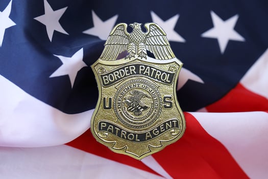 KYIV, UKRAINE - MARCH 9, 2024 US Border Patrol Agent badge on United States of America flag photo