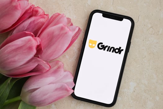 KYIV, UKRAINE - FEBRUARY 23, 2024 Grindr logo of famous dating website or app on iPhone display photo