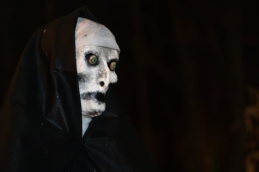 Spooky Halloween decoration stands in a wooded area creating a sinister atmosphere photo