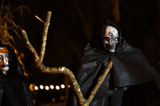 Spooky Halloween decoration stands in a wooded area creating a sinister atmosphere photo