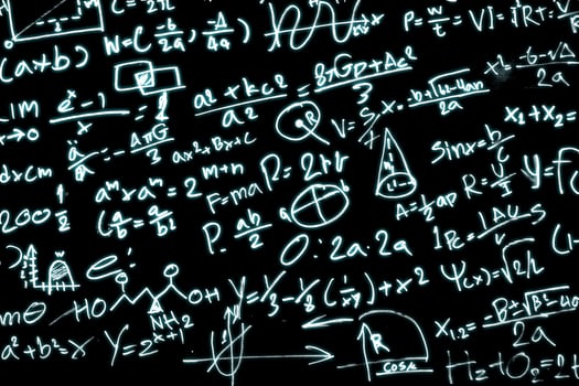 Black paper with a lot of mathematical formulas photo