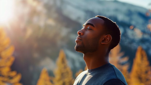 Black man breaths fresh air on the forest. photo
