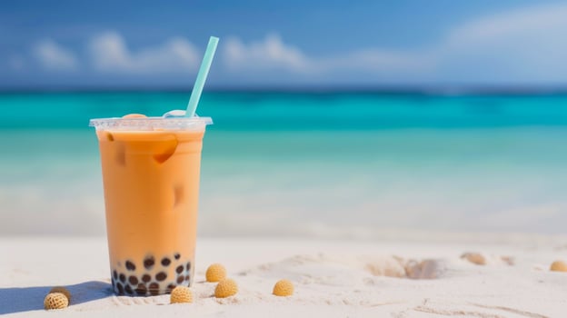 orange bubble tea in front of blurred holiday beach resort in background photo