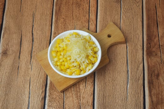 Shaved corn sprinkled with cheese and sweet milk photo
