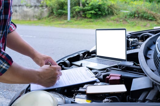 Professional auto mechanic working in repairing service, close-up. Car diagnostics concept photo