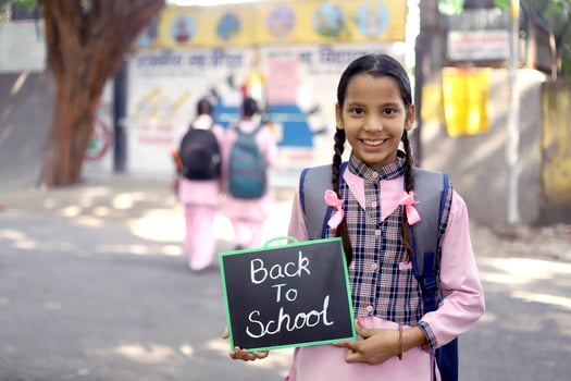 Rural Girl Students Standing Outside The School And Holding Black Slate In Their Hands photo