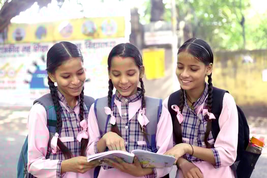 Village Kids Posing In Front Of The Camera While Holding Books photo