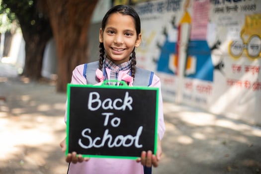Smiling And Showing Thumbs Up slete in front of school photo