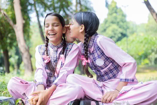 Female Friends Laughing While Playing Games In The Park photo