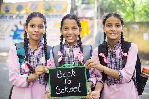 Close-Up Shot Of Smiling Clever Girl In School Dress Posing In Front Of Blur School Campus Background photo