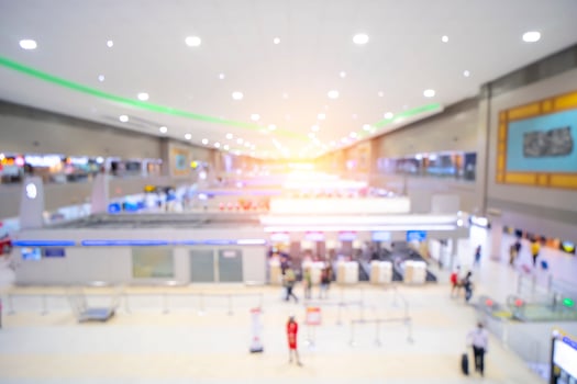 Traveler at airport terminal. Blur background with bokeh light. Empty airport during a pandemic Coronavirus, COVID-19 concept. photo